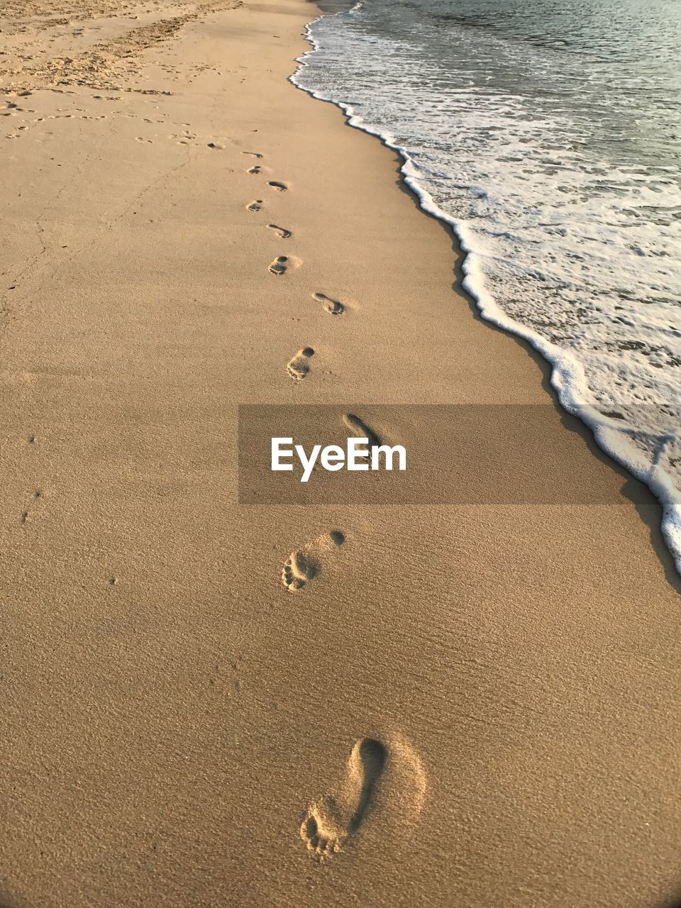 High angle view of footprints on beach