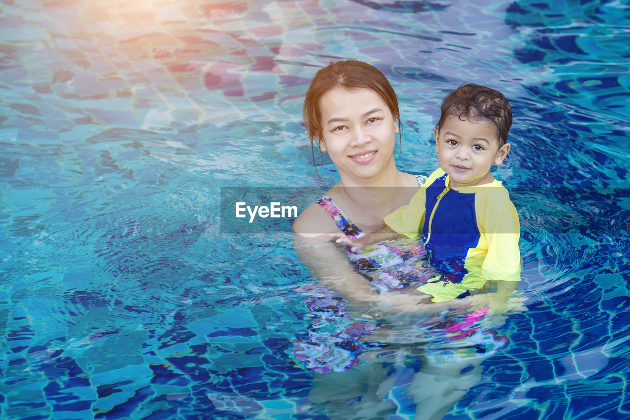 Portrait of mother with son in swimming pool