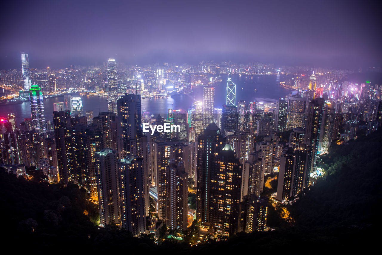 High angle view of illuminated cityscape against sky at night