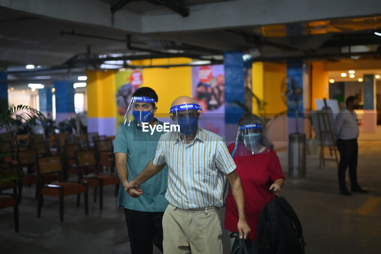 PEOPLE STANDING IN ILLUMINATED TRADITIONAL CLOTHING