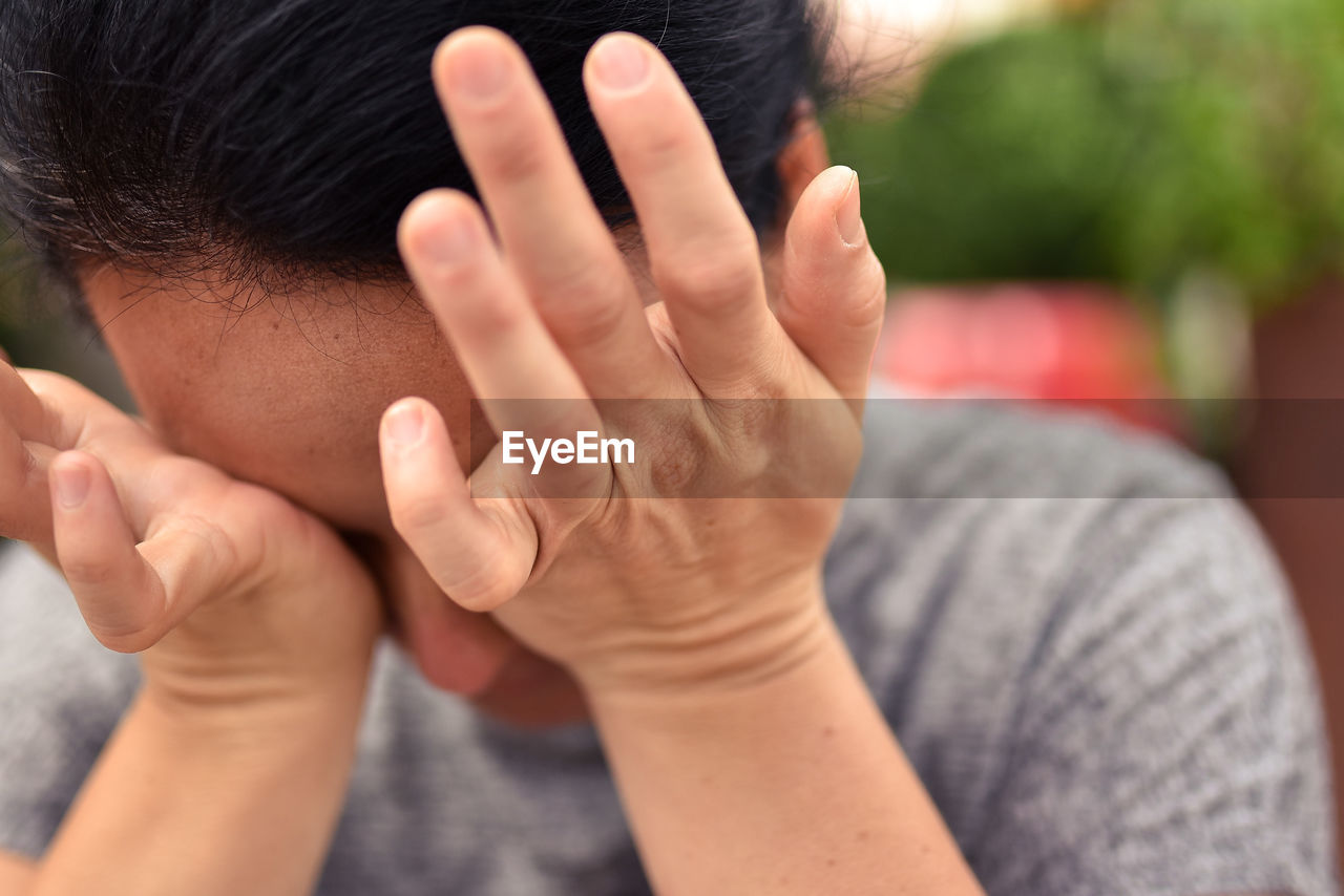 Close-up of woman rubbing eyes