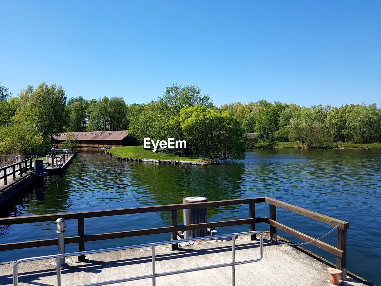 Scenic view of river against clear blue sky