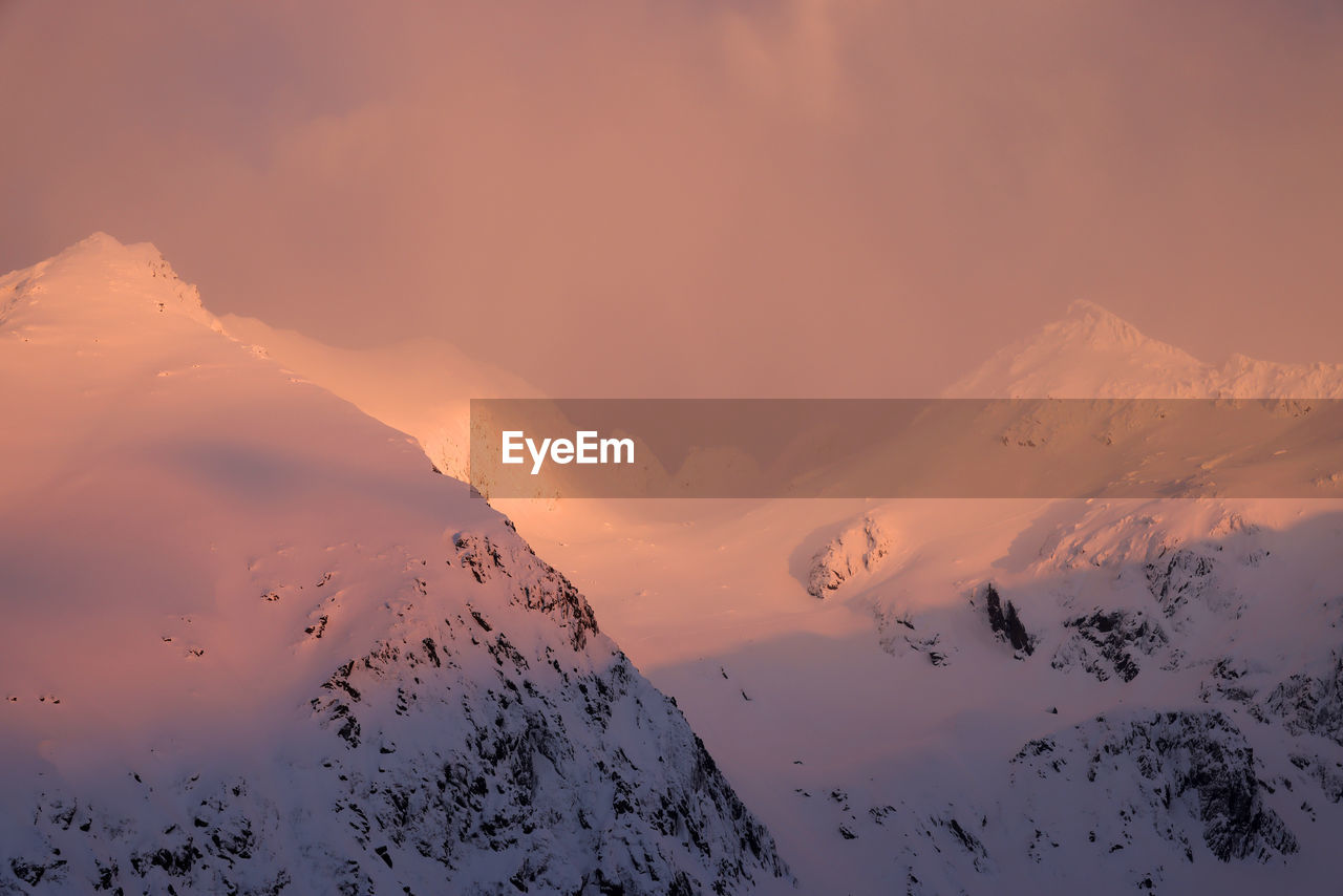 low angle view of snowcapped mountains against sky during sunset