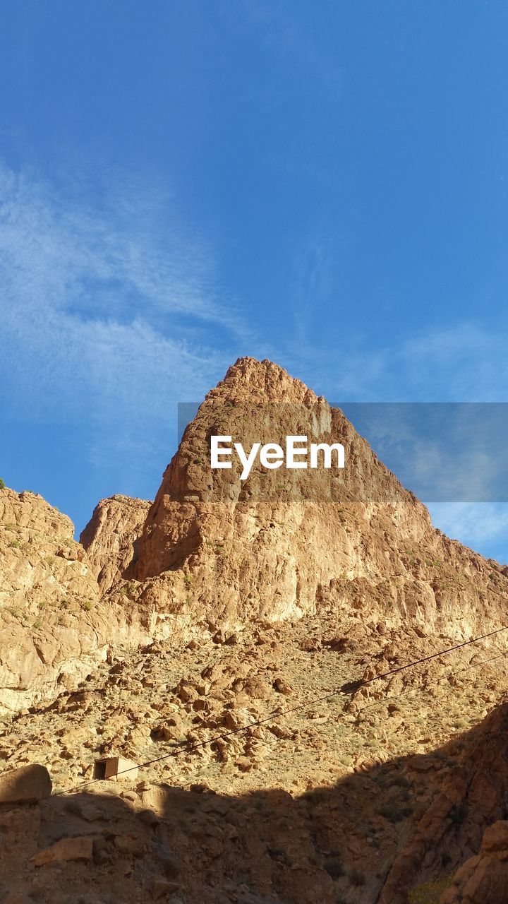 LOW ANGLE VIEW OF ROCK FORMATION ON LAND AGAINST SKY