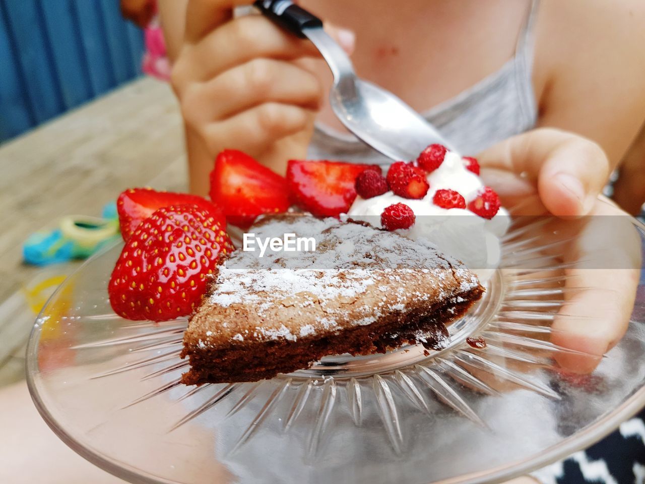 Midsection of woman holding dessert in plate