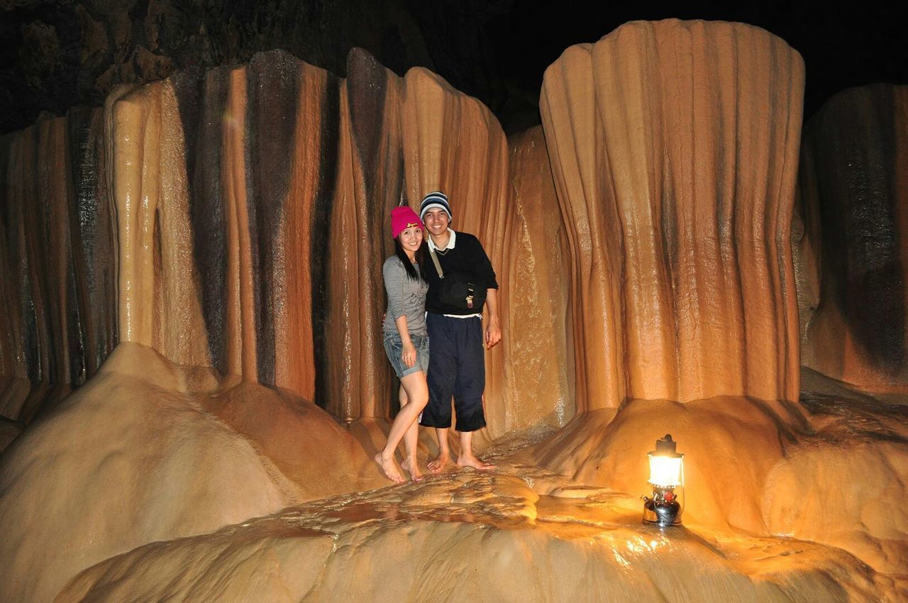 Couple standing together on rock