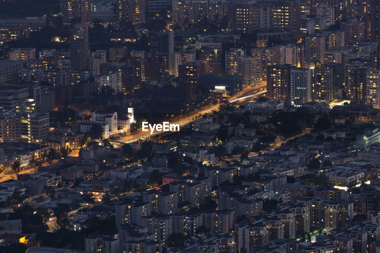 High angle view of illuminated city buildings at night