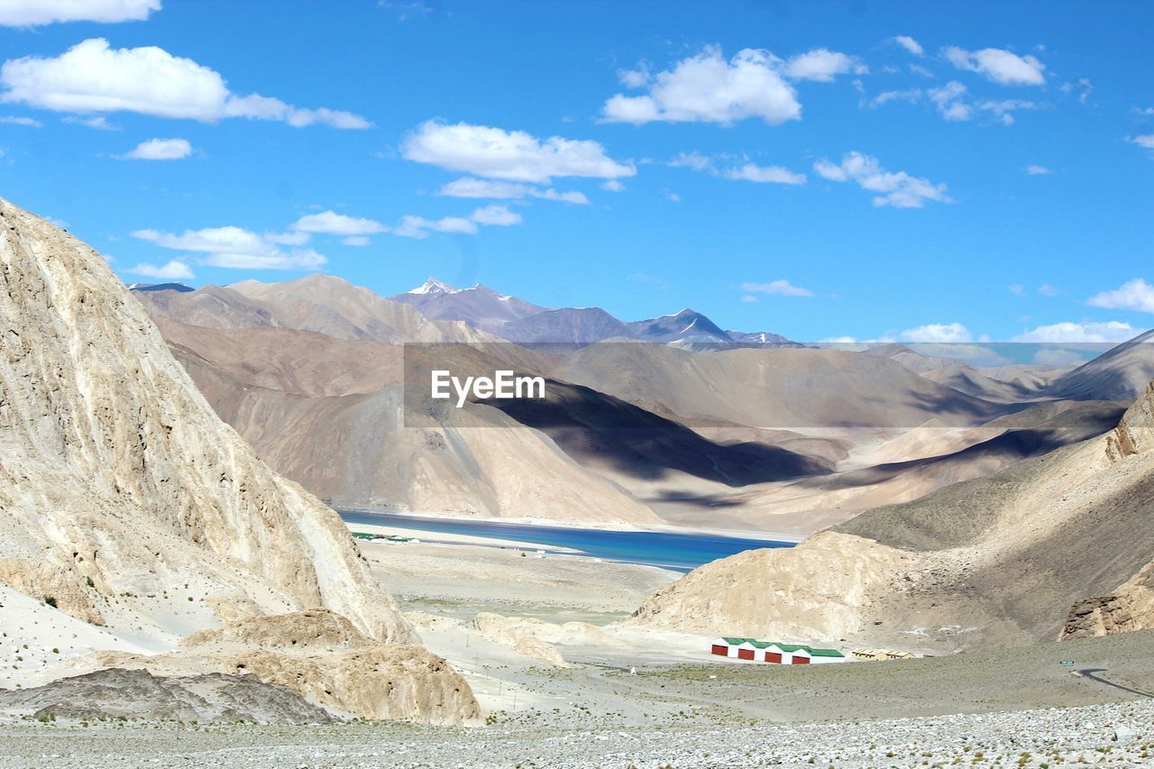 Scenic view of lake and mountains against sky at ladakh region