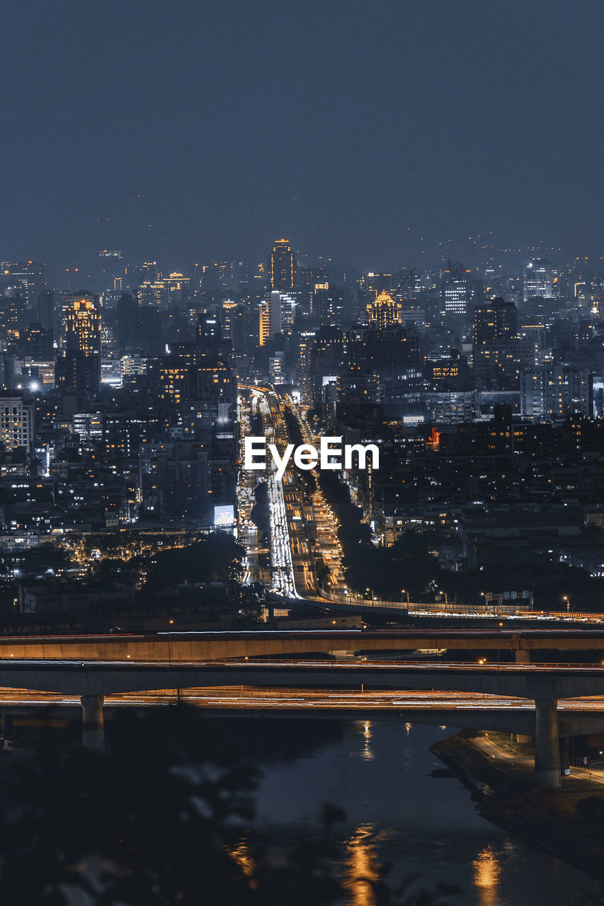 High angle view of illuminated buildings in city at night