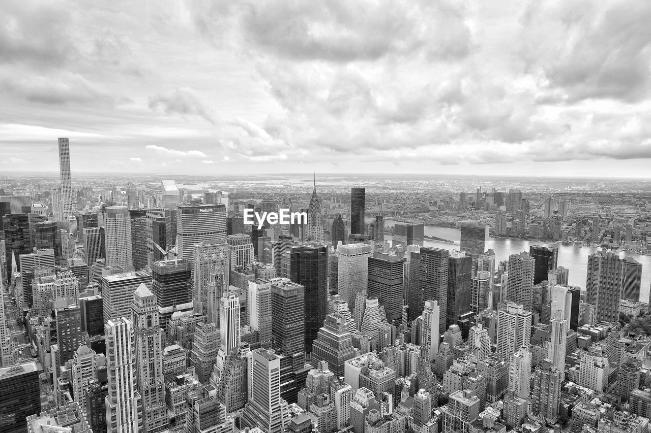 High angle view of modern buildings in city against sky