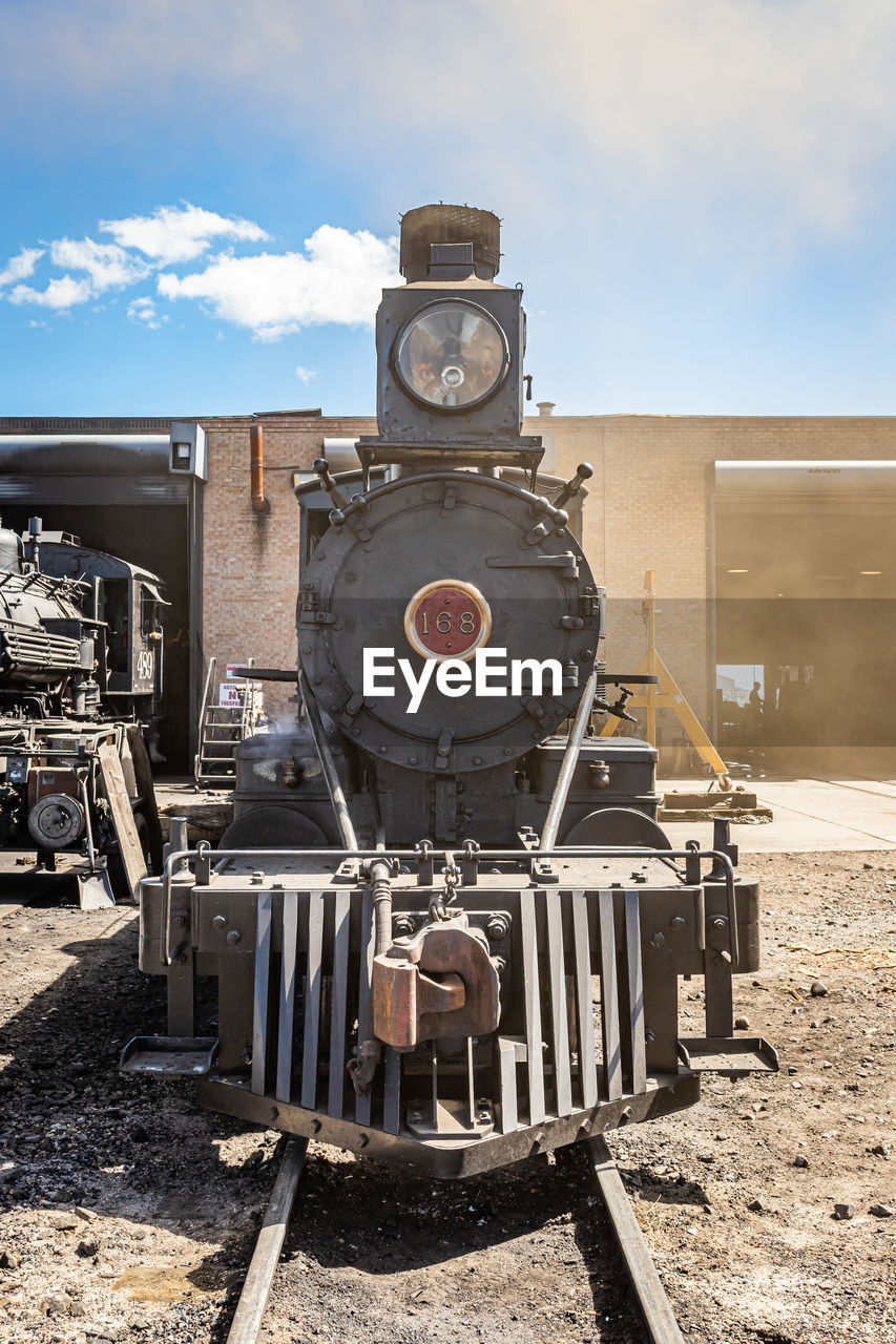 train, transport, vehicle, locomotive, sky, rail transportation, cloud, railway, transportation, nature, land vehicle, day, sunlight, steam engine, no people, mode of transportation, railroad track, track, outdoors, steam train