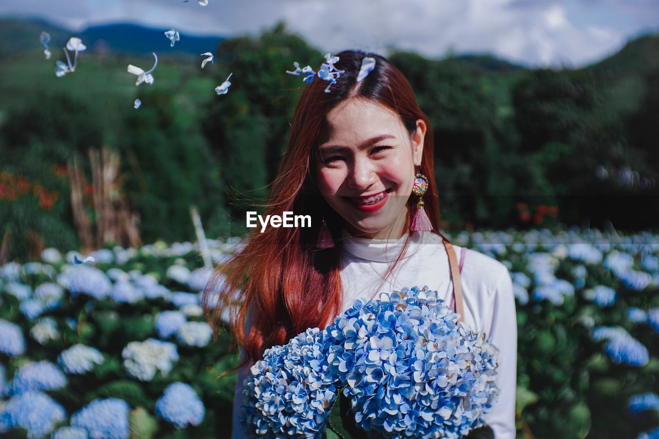 Portrait of smiling woman with flowers