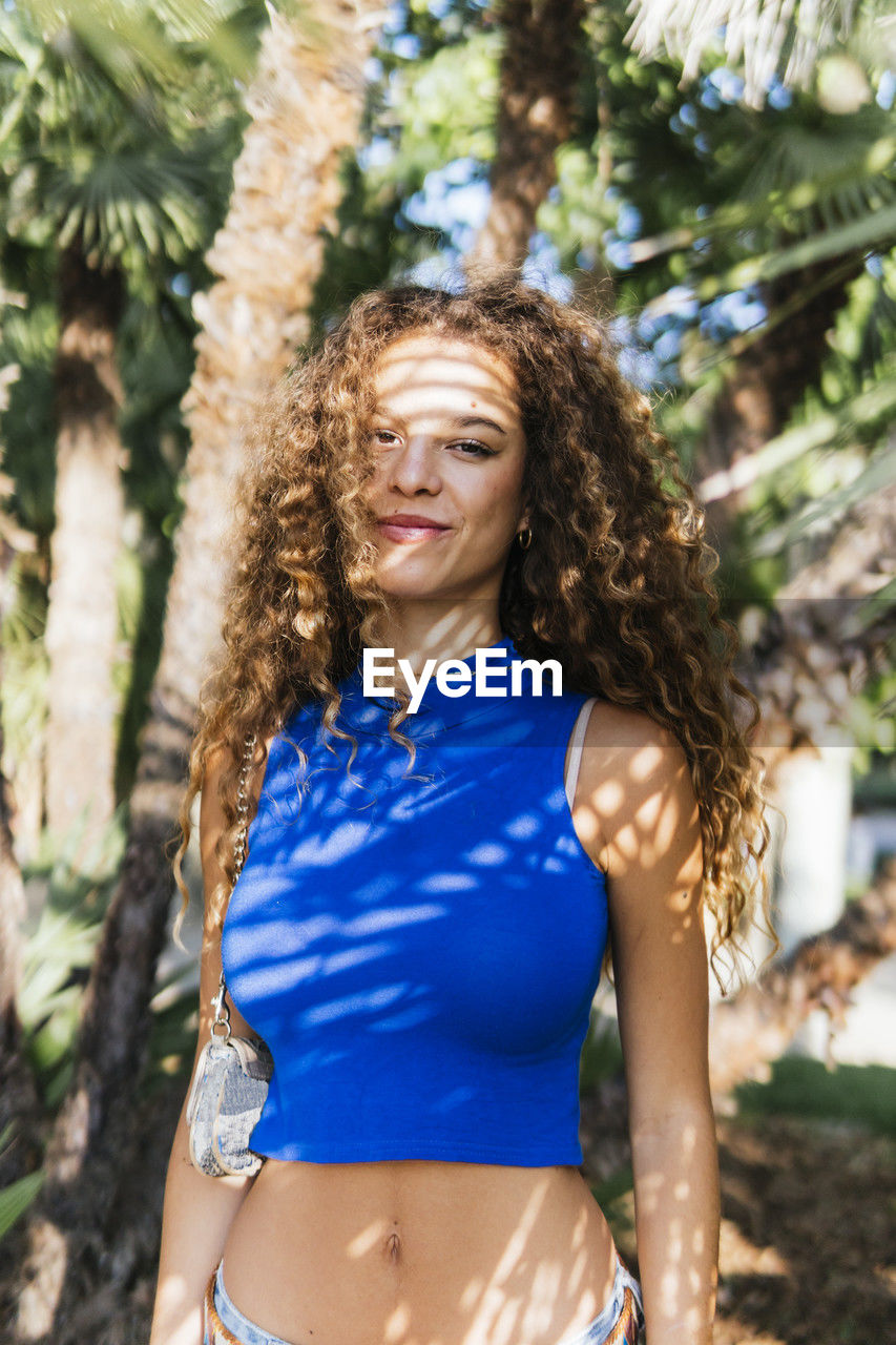 Smiling woman with long curly hair
