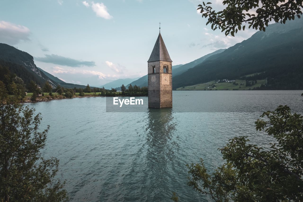 View of lake by building against sky