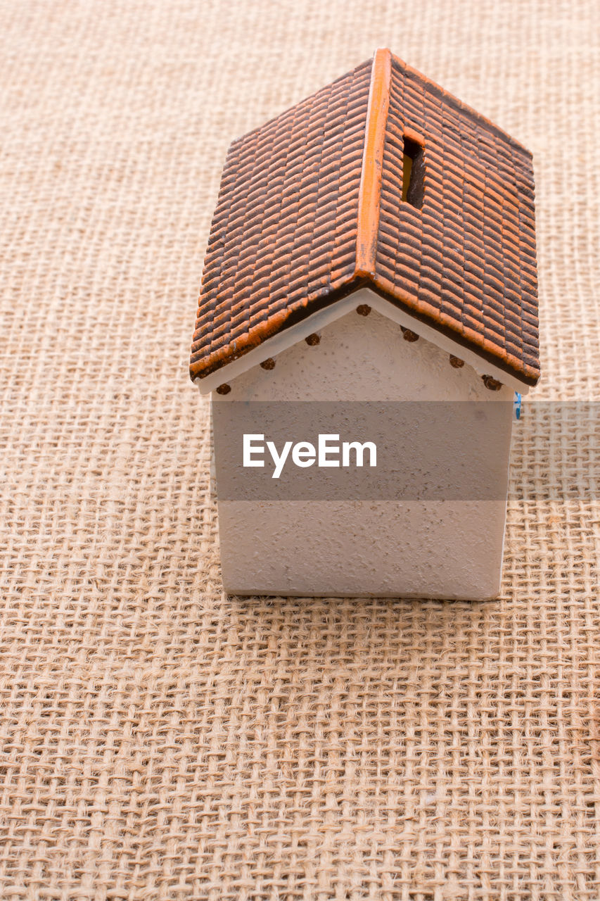High angle view of model home on burlap