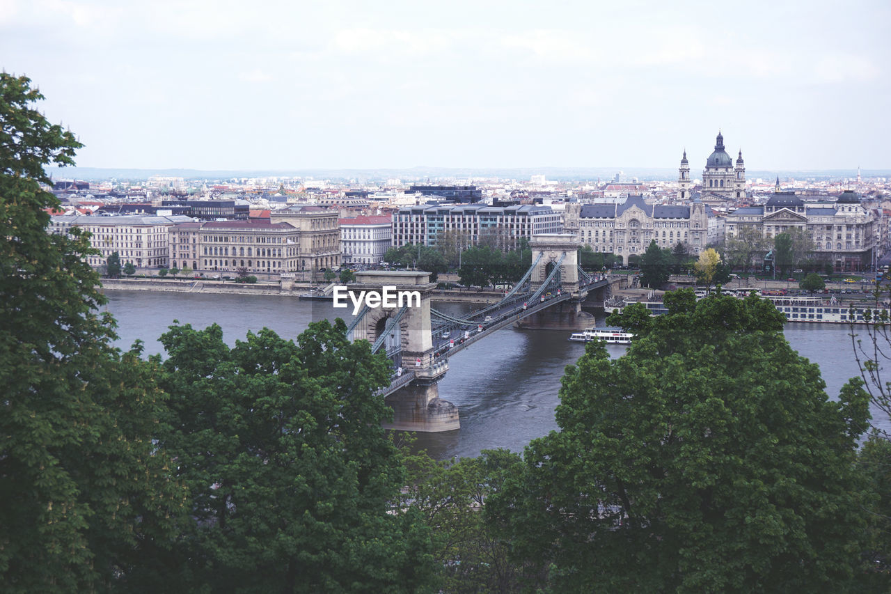 Bridge over river with city in background