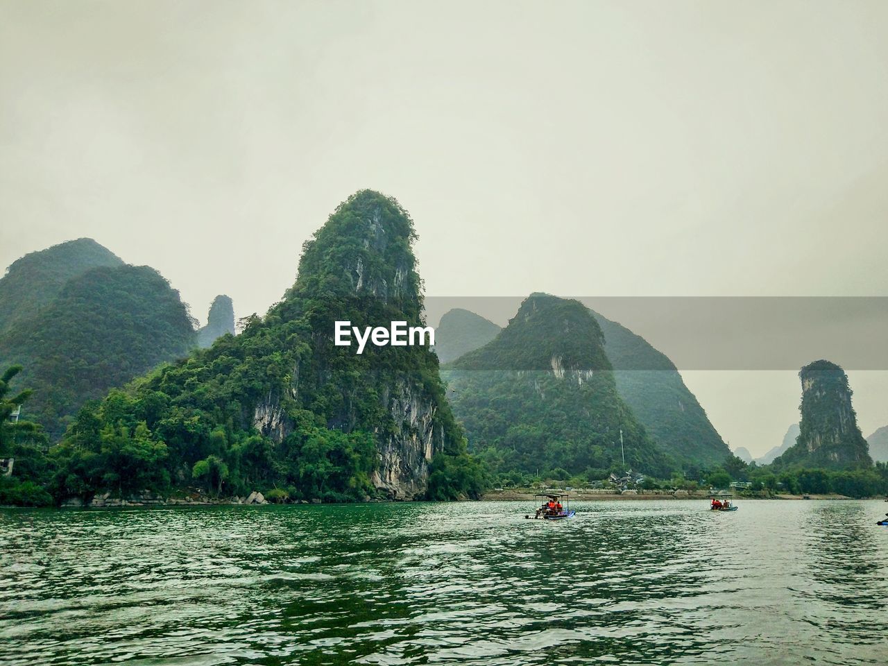 VIEW OF RIVER WITH MOUNTAIN IN BACKGROUND