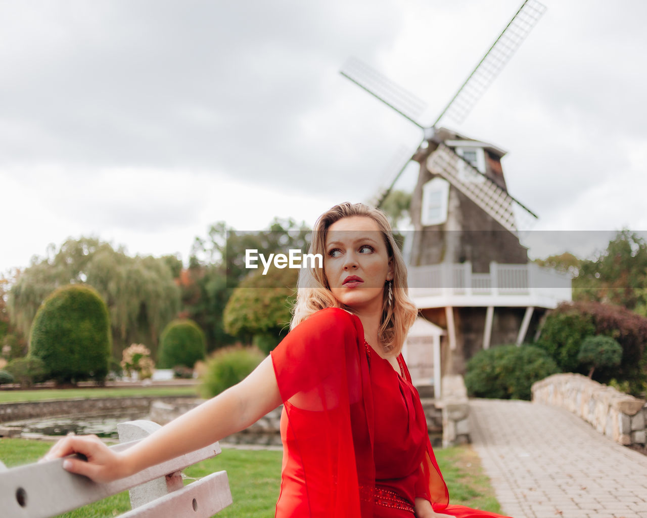 Portrait of woman standing against sky