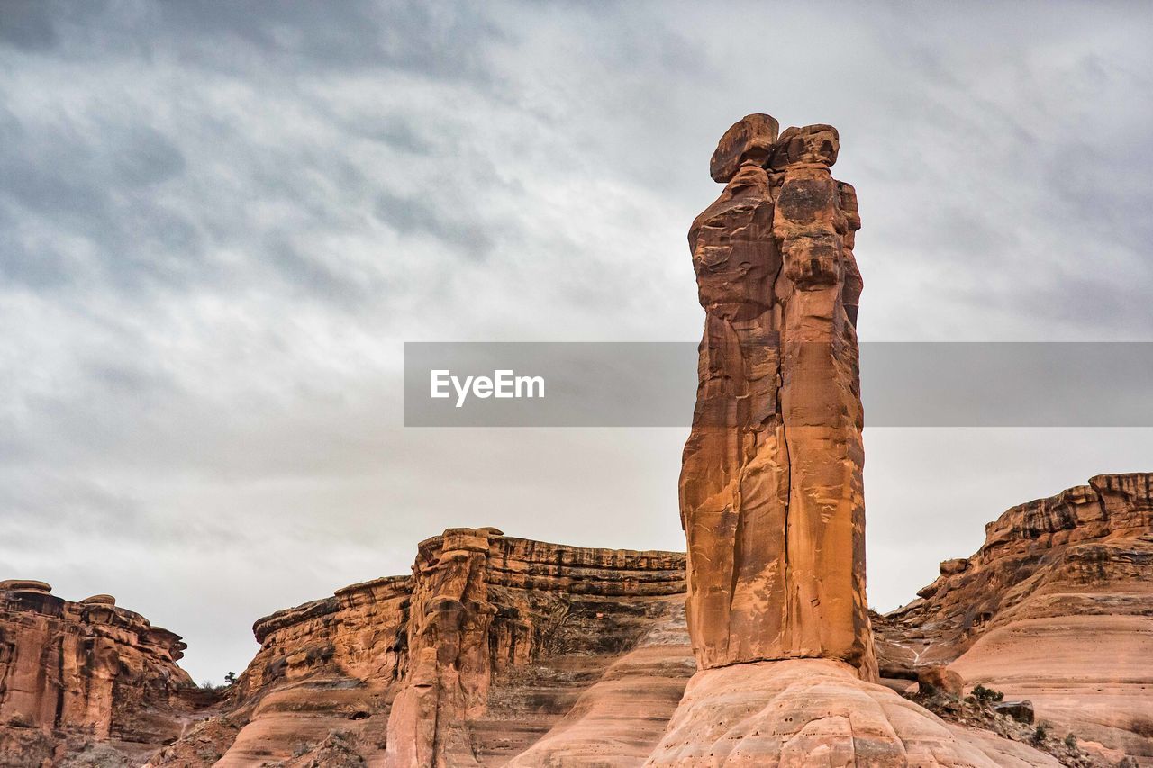 Low angle view of rock formations against sky at arches national park