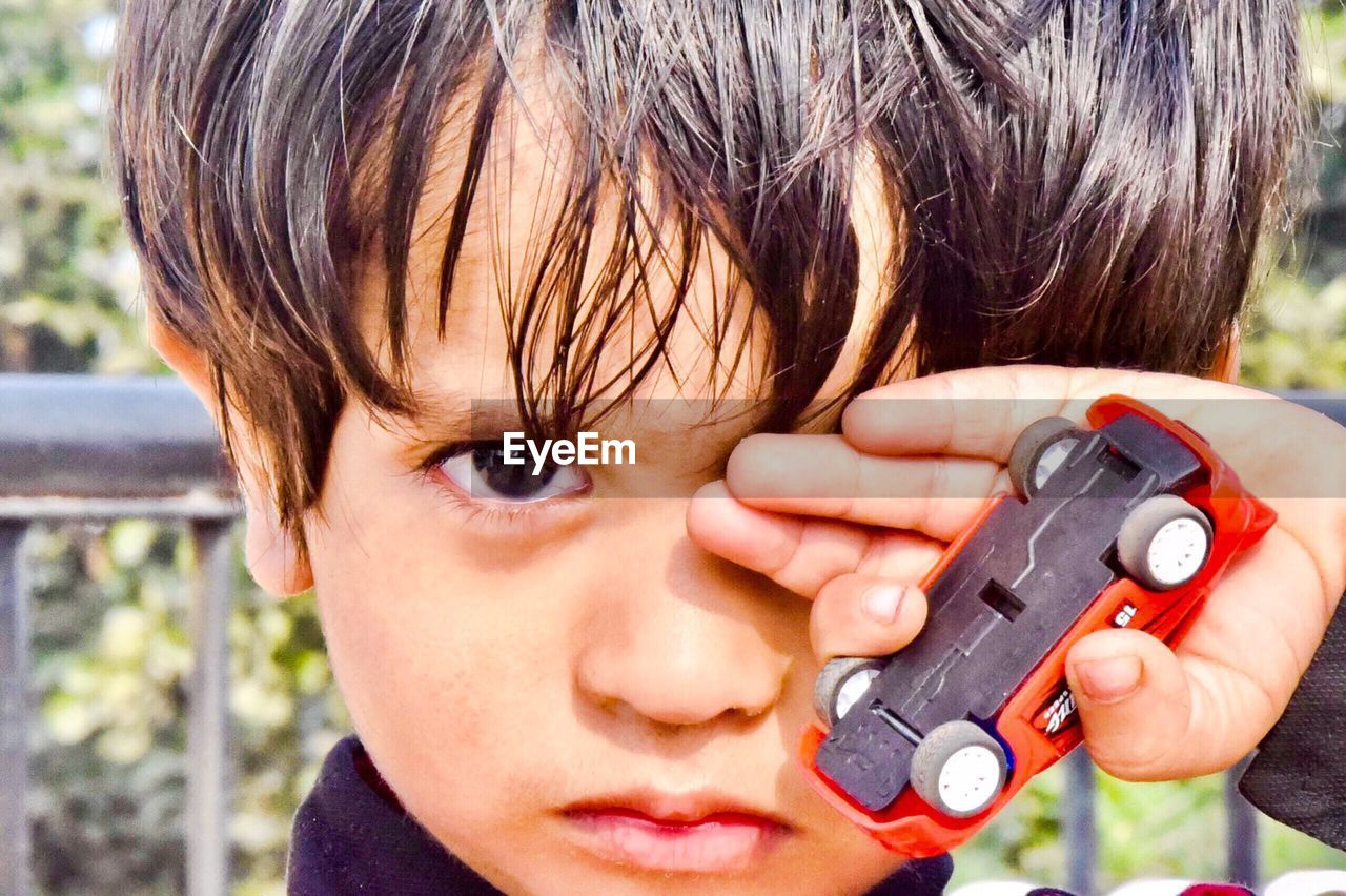 CLOSE-UP PORTRAIT OF BOY WITH TATTOO