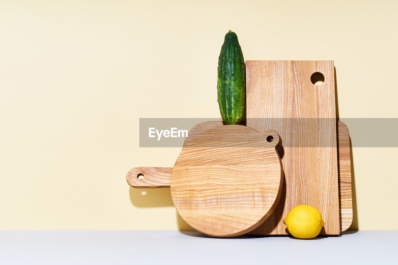 Wooden cutting boards of various shapes on bright studio background