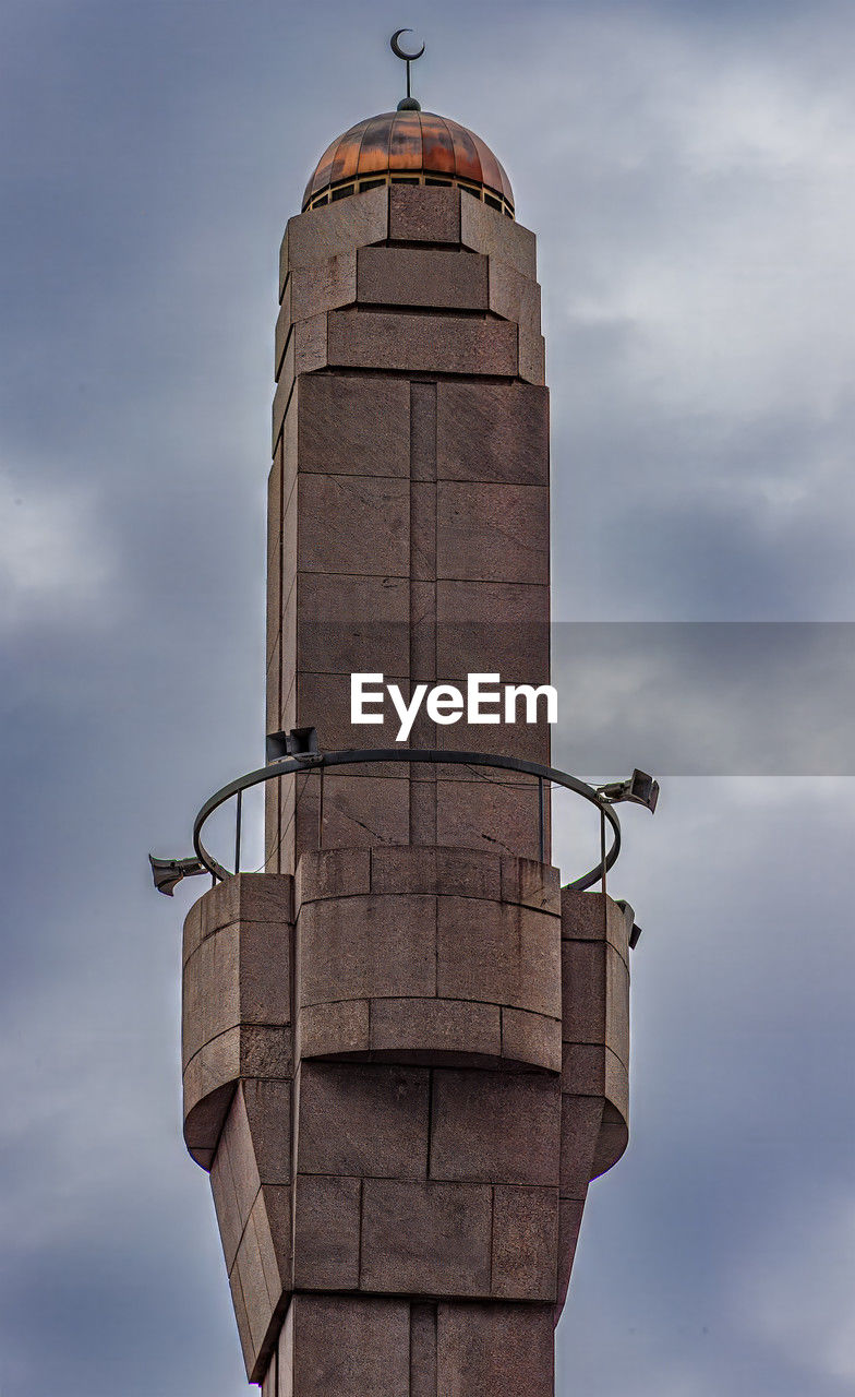 low angle view of bird perching on pole against sky