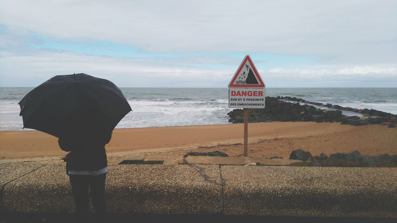 Man on beach against sky