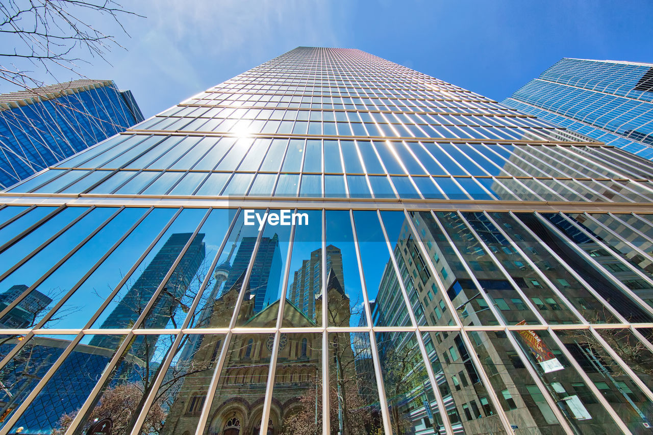 Low angle view of modern building against blue sky