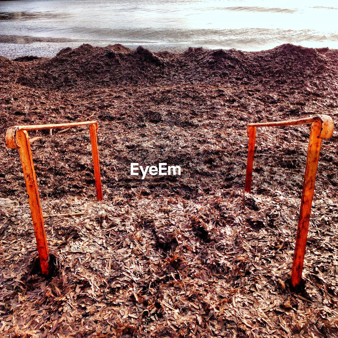 HIGH ANGLE VIEW OF BEACH AGAINST ORANGE SKY