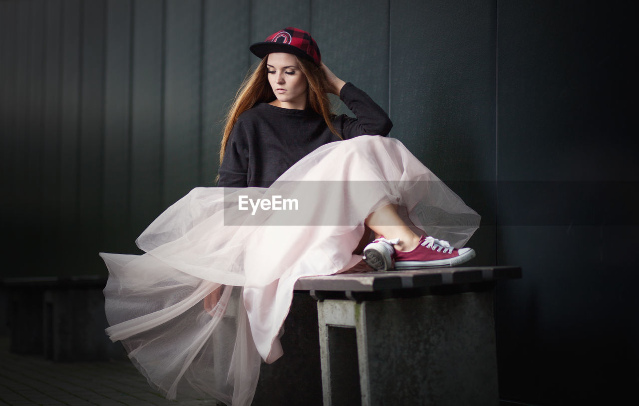 Young woman sitting on bench