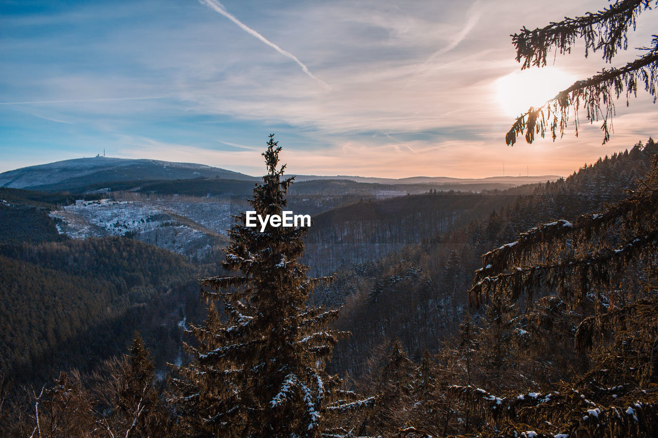 Scenic view of snowcapped mountains against sky during sunset