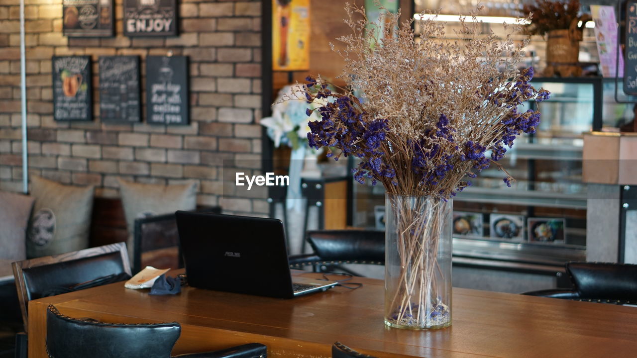 Close-up of flower vase on table in restaurant