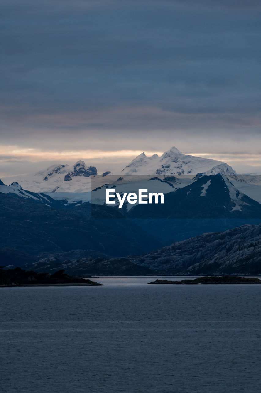 Scenic view of snowcapped mountains against sky during sunset