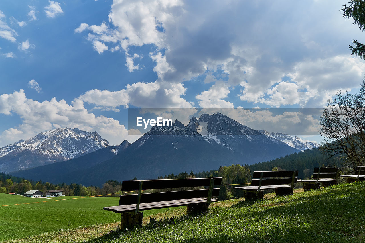 Scenic view of field and mountains against sky