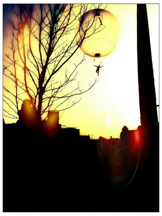 VIEW OF ILLUMINATED STREET LIGHTS AT SUNSET