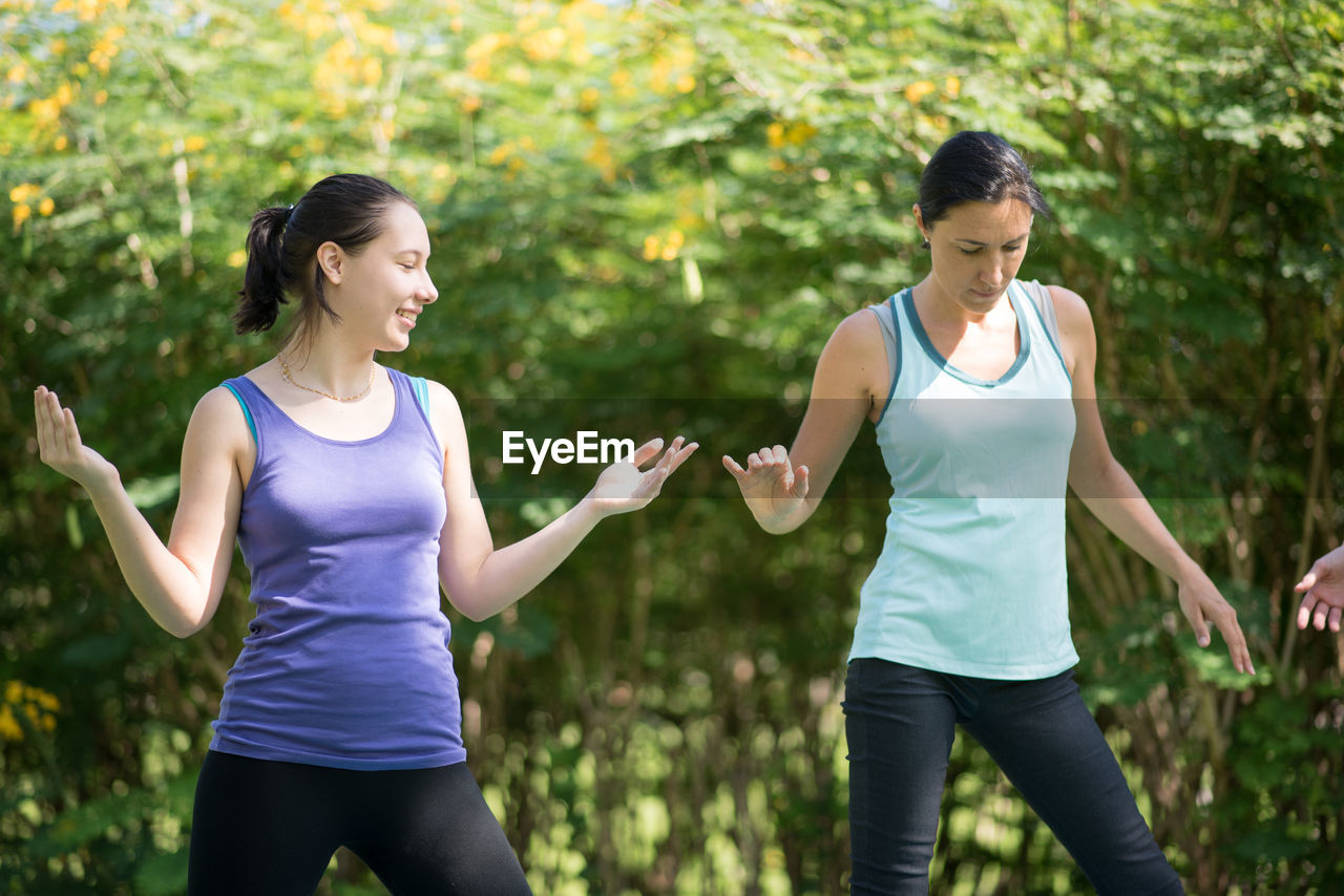 People doing yoga in park