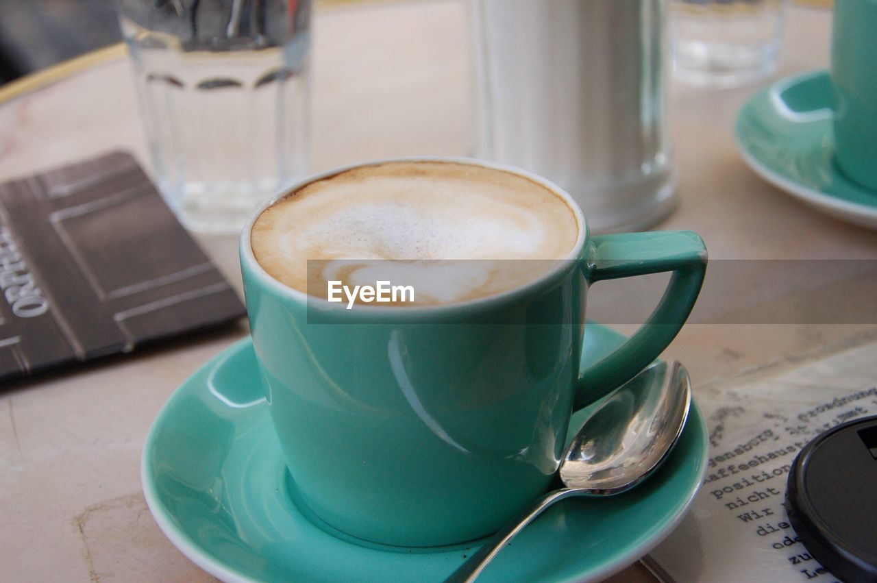 CLOSE-UP OF COFFEE CUP ON TABLE