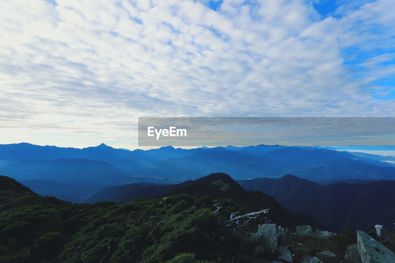 SCENIC VIEW OF LANDSCAPE AND MOUNTAINS AGAINST SKY