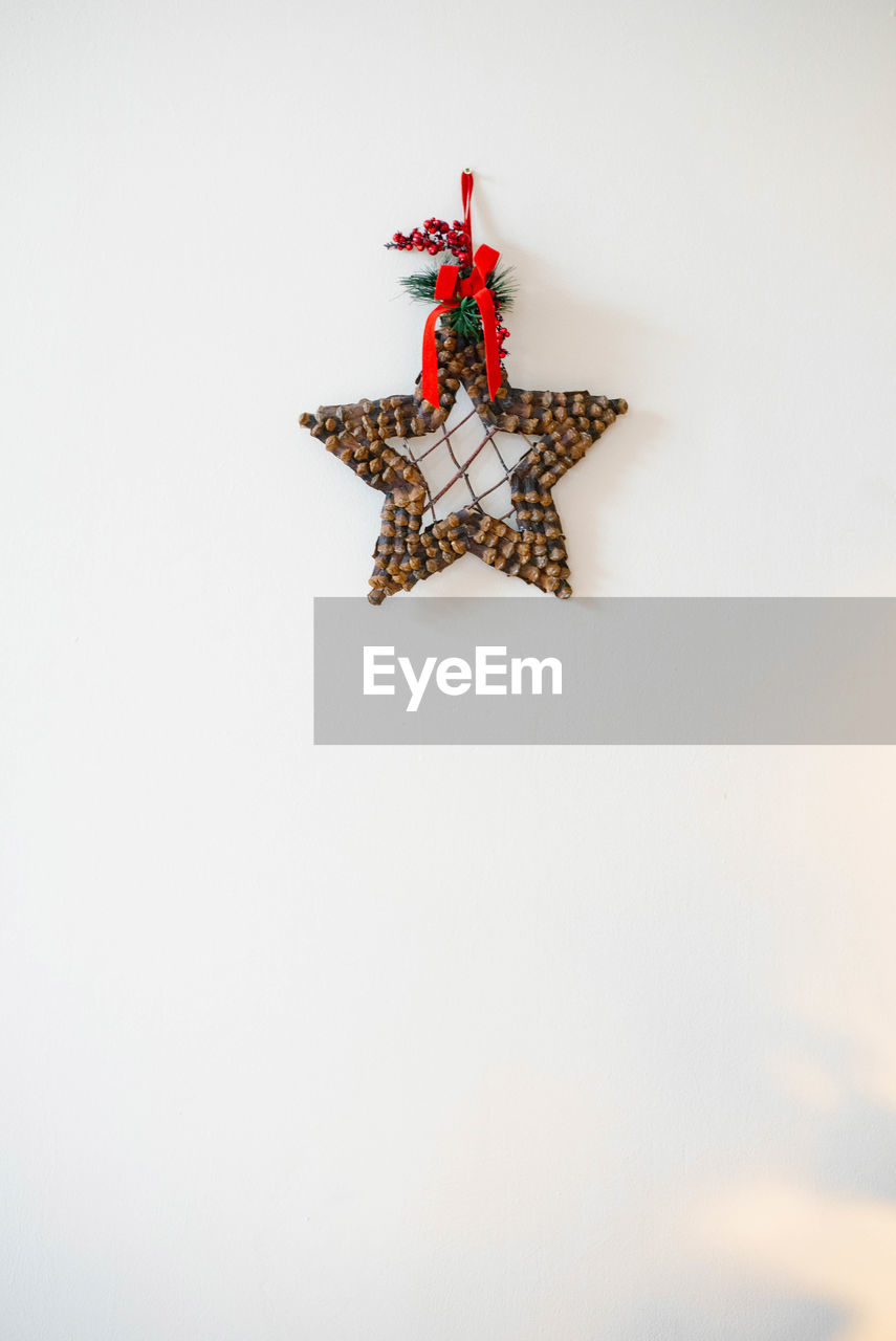 Homemade christmas star wreath on white background with copy space