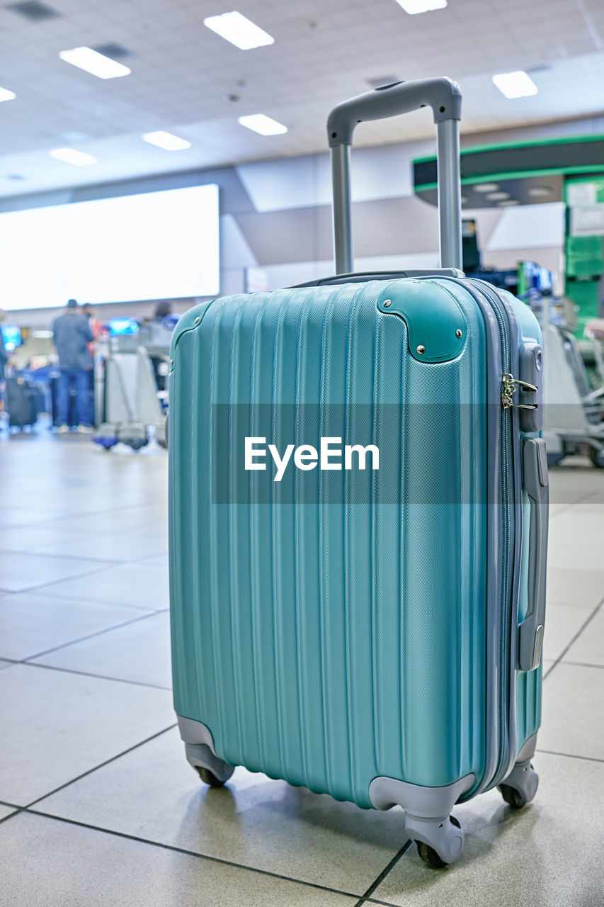 Suitcase or baggage with airport luggage trolley in the international airport, focus on suitcases. 