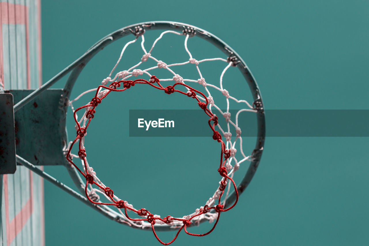 Low angle view of basketball hoop against clear blue sky during sunny day