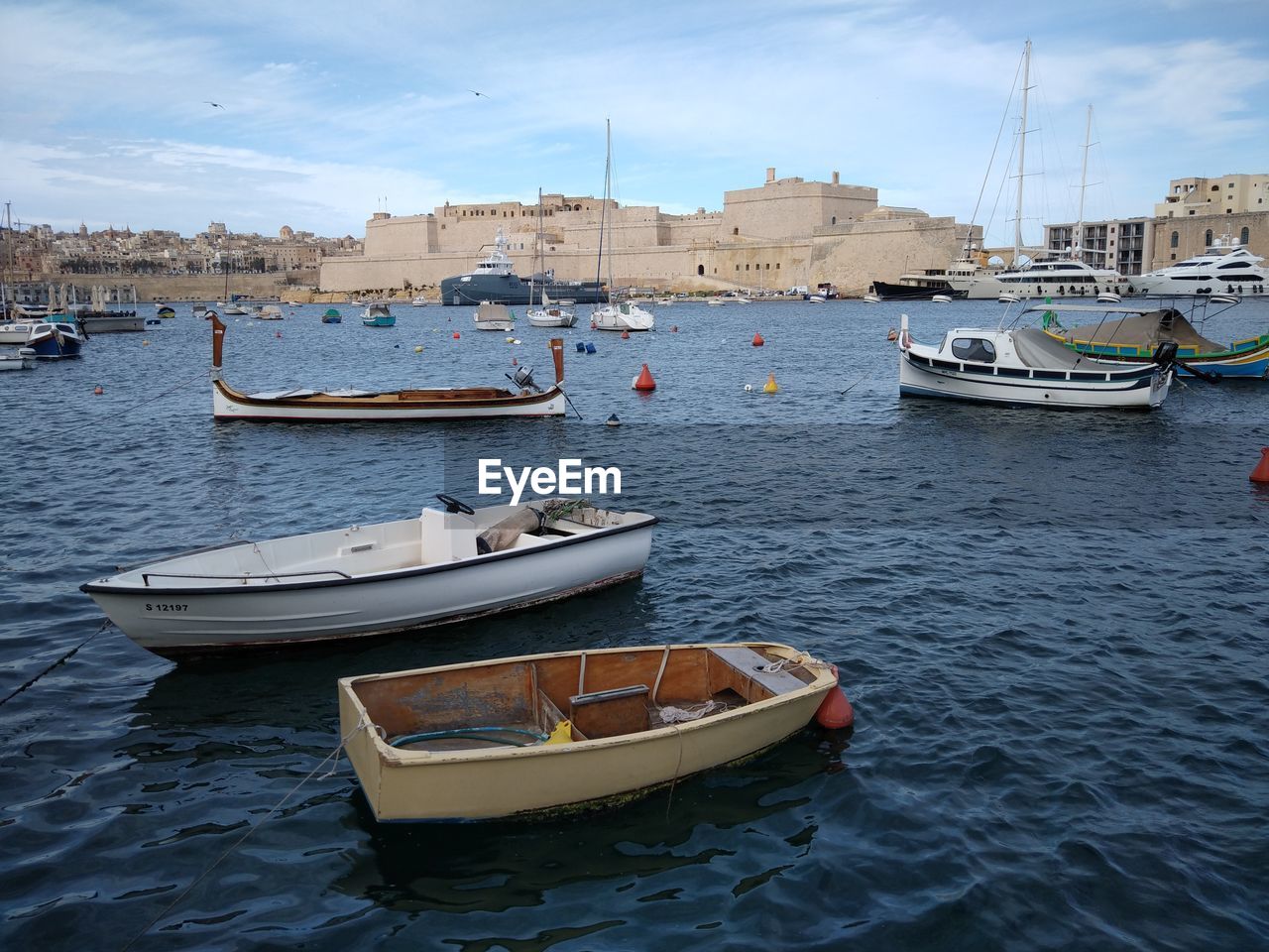 SAILBOATS MOORED IN SEA