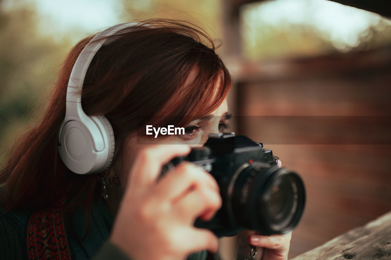 Close-up of woman photographing outdoors