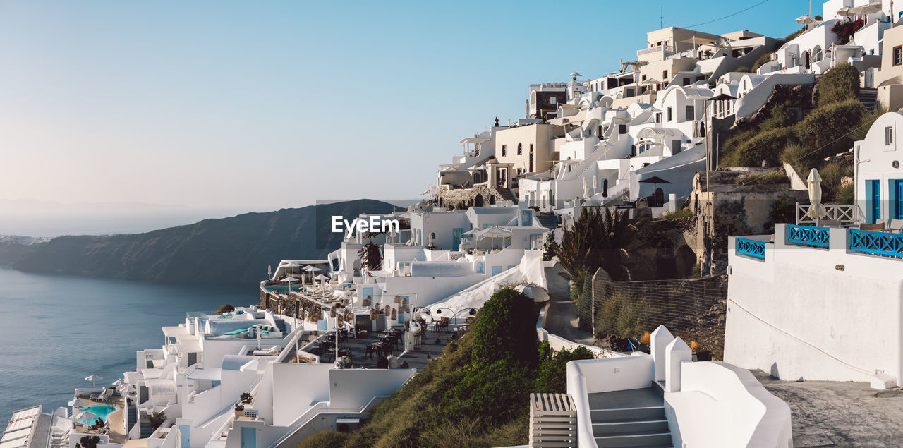 High angle view of townscape by sea against clear sky