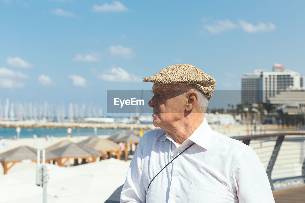 Portrait of man wearing hat against sea against sky