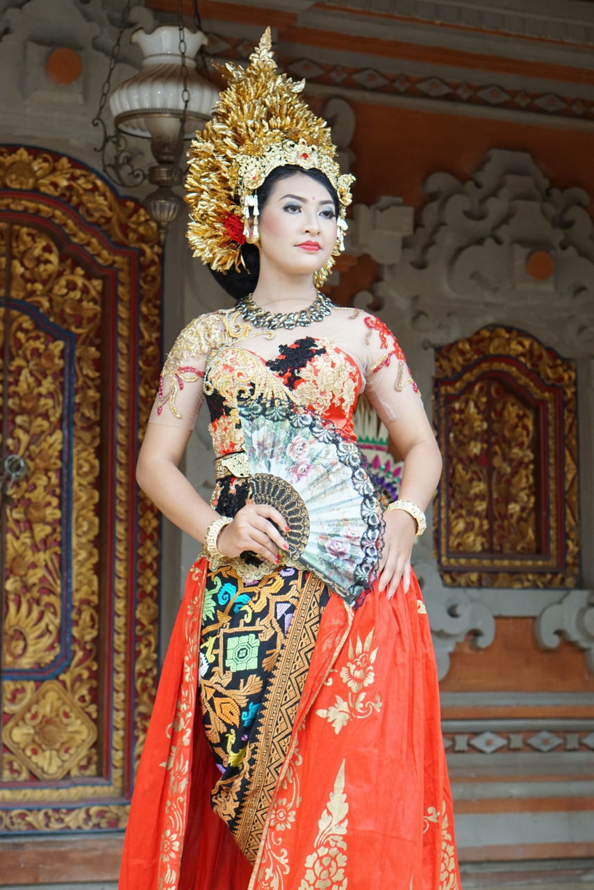 PORTRAIT OF YOUNG WOMAN WEARING MASK