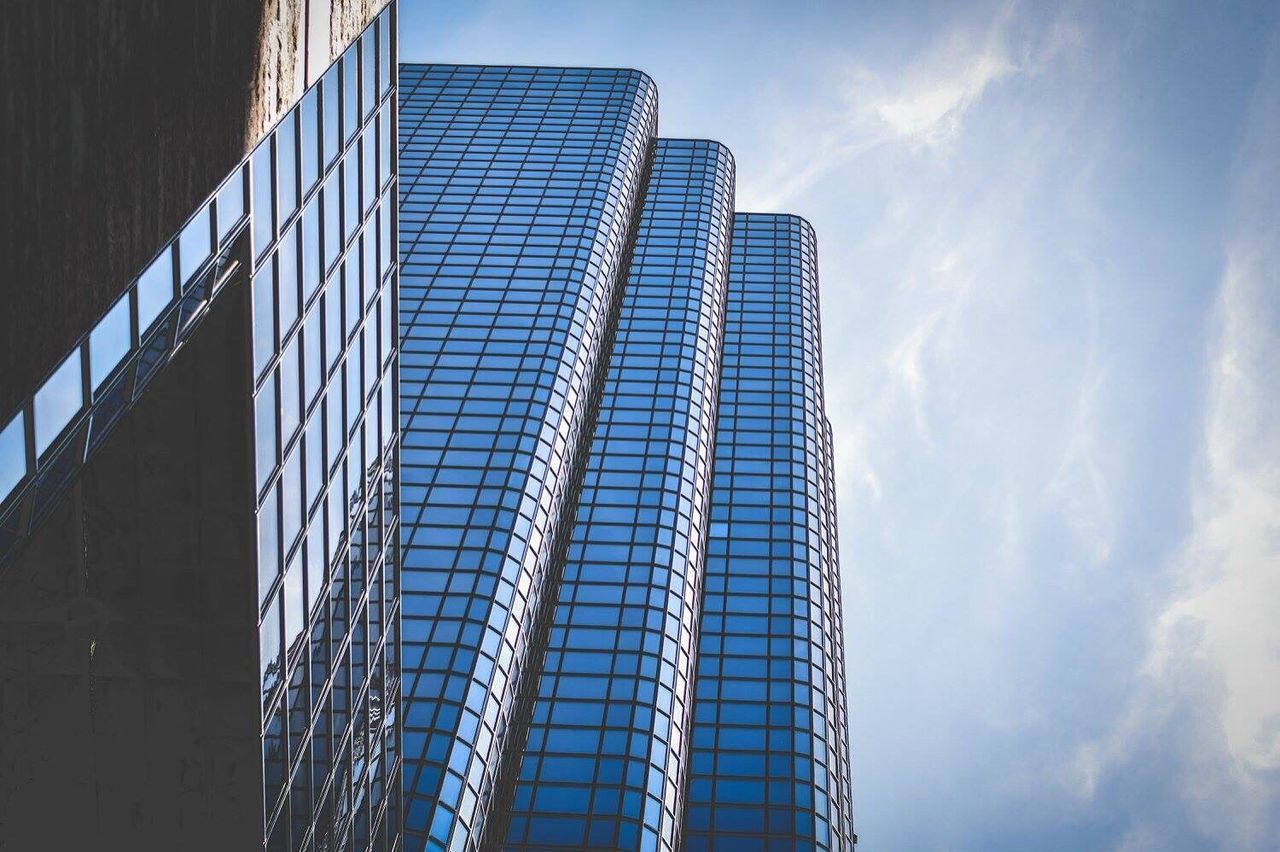 architecture, skyscraper, modern, built structure, building exterior, low angle view, day, tower, sunlight, sky, no people, city, outdoors