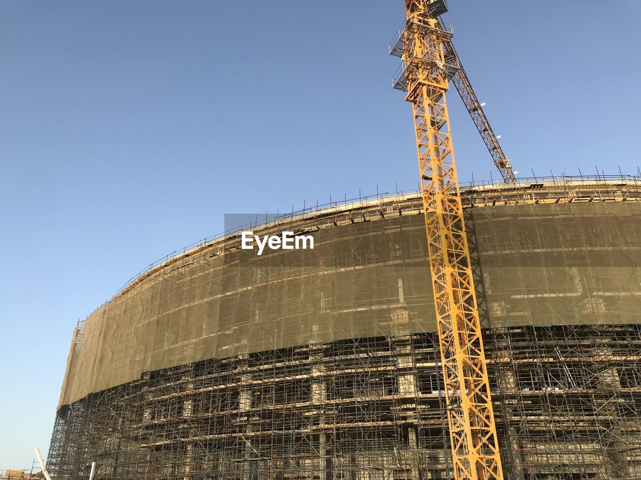 LOW ANGLE VIEW OF CRANE AGAINST SKY