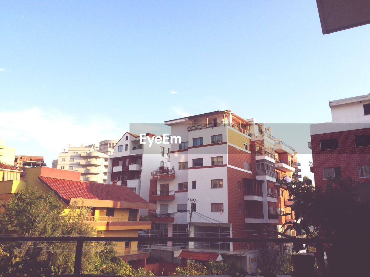 Residential buildings under clear sky at sunset