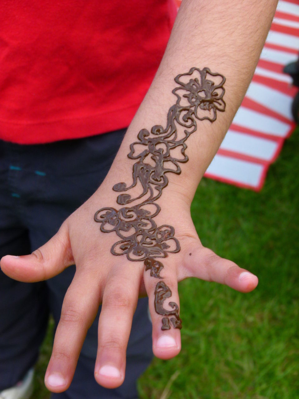 Cropped image of man showing henna tattoo
